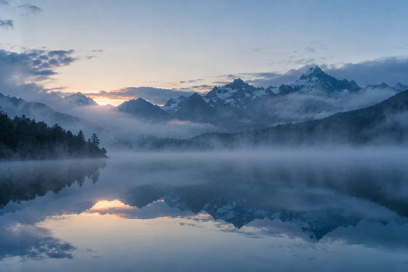 The lake at first light, flat calm with mist rising